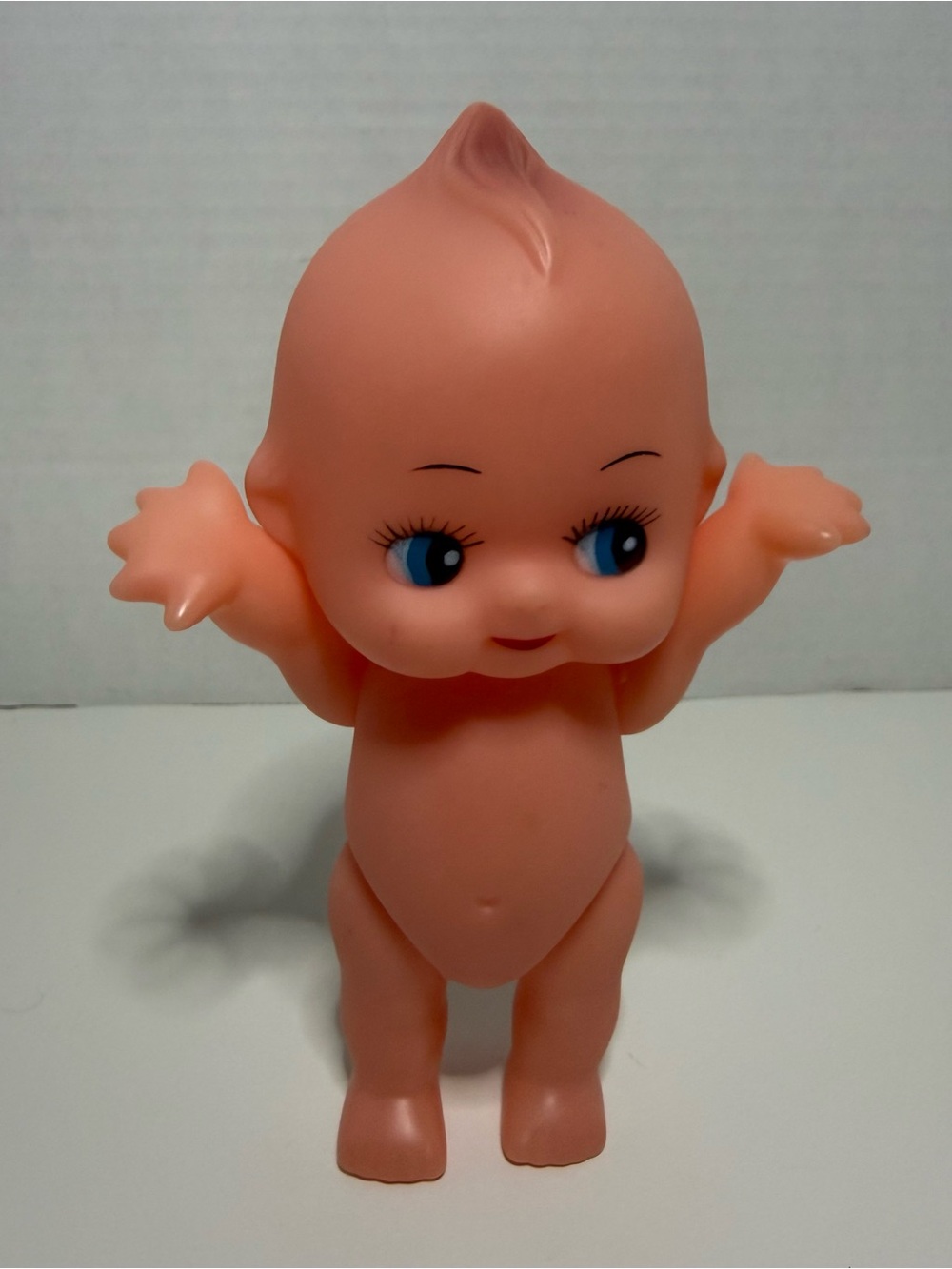 Peach Vinyl Kewpie-Style Baby Doll with Blue Eyes